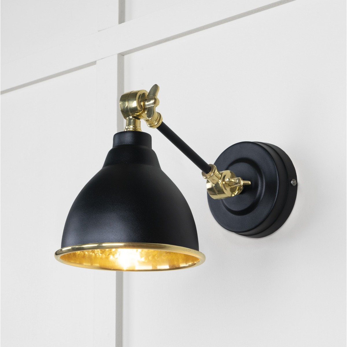 From the Anvil Hammered Brass Brindley Wall Light in Elan Black 49719SEB