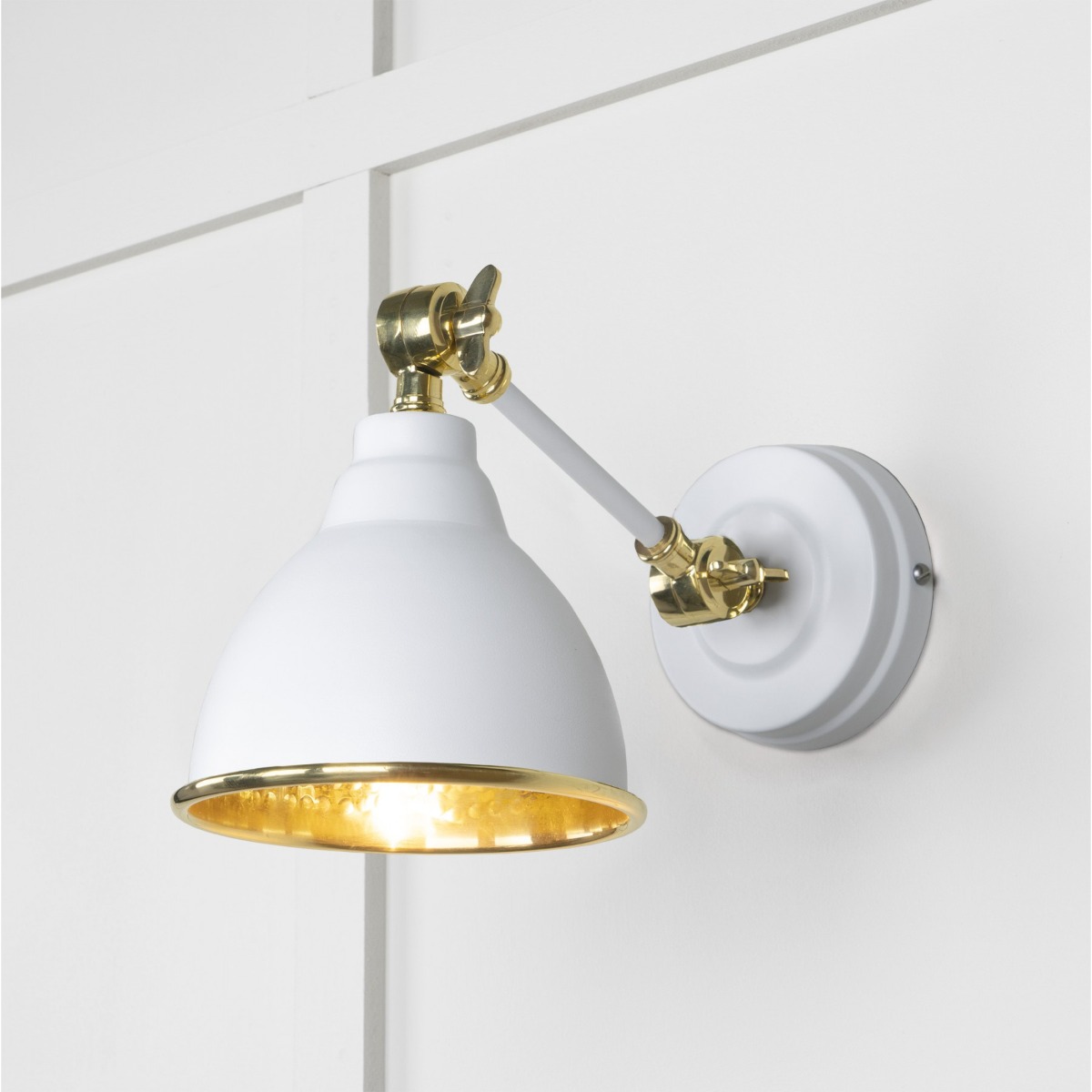 From the Anvil Hammered Brass Brindley Wall Light in Flock 49719SF