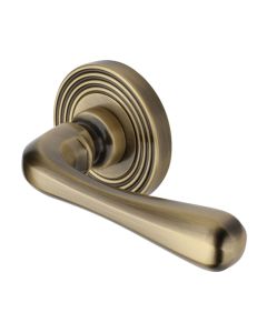 Heritage Brass Door Handle Lever Latch on Round Rose Charlbury Reeded Design Antique Brass 
  RR3022-AT