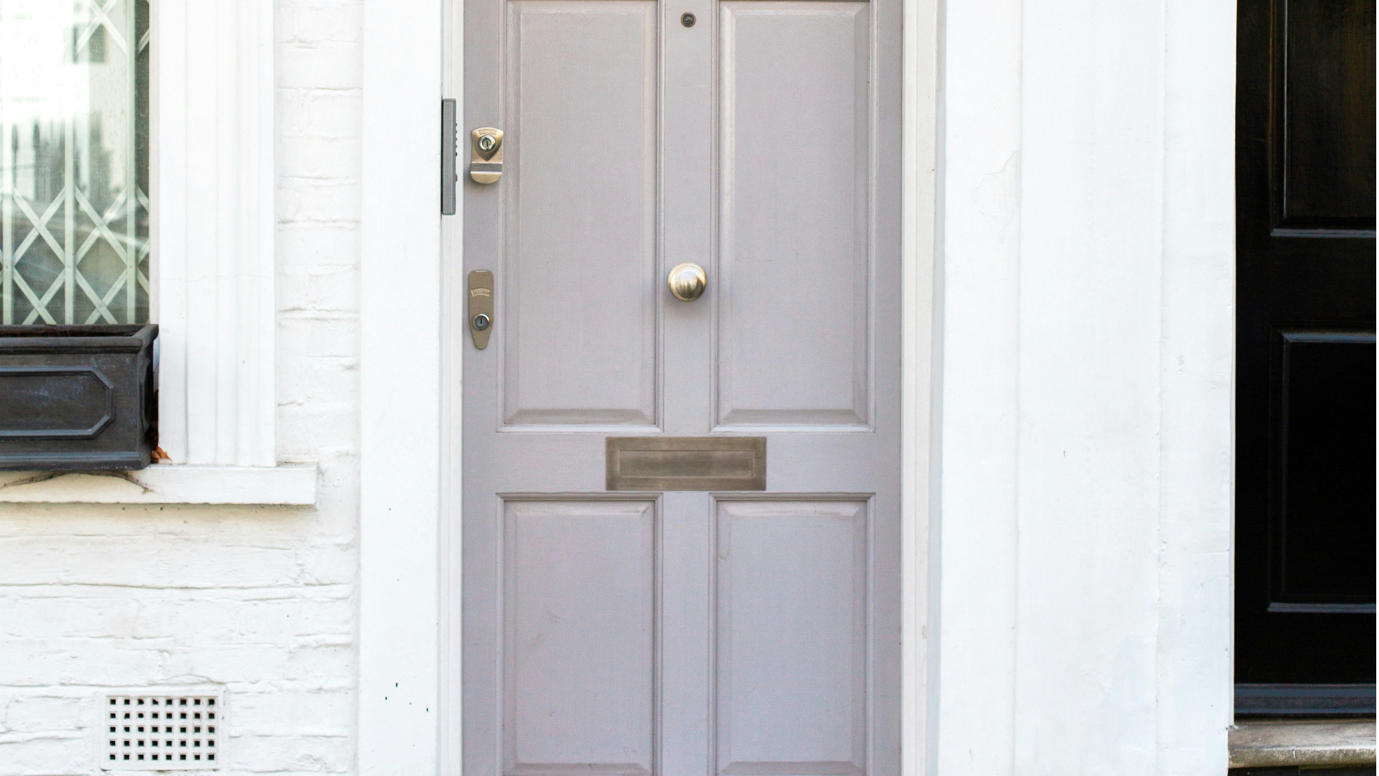 A letterbox in a grey front door
