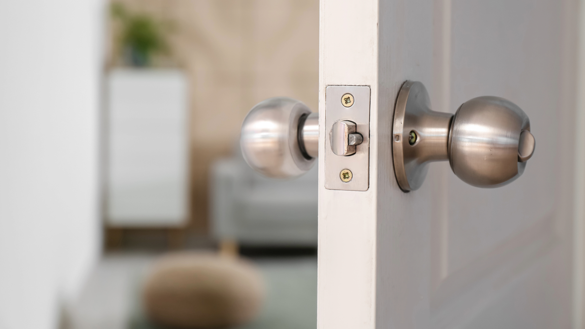 A door is ajar, leading into a bathroom which is out of focus