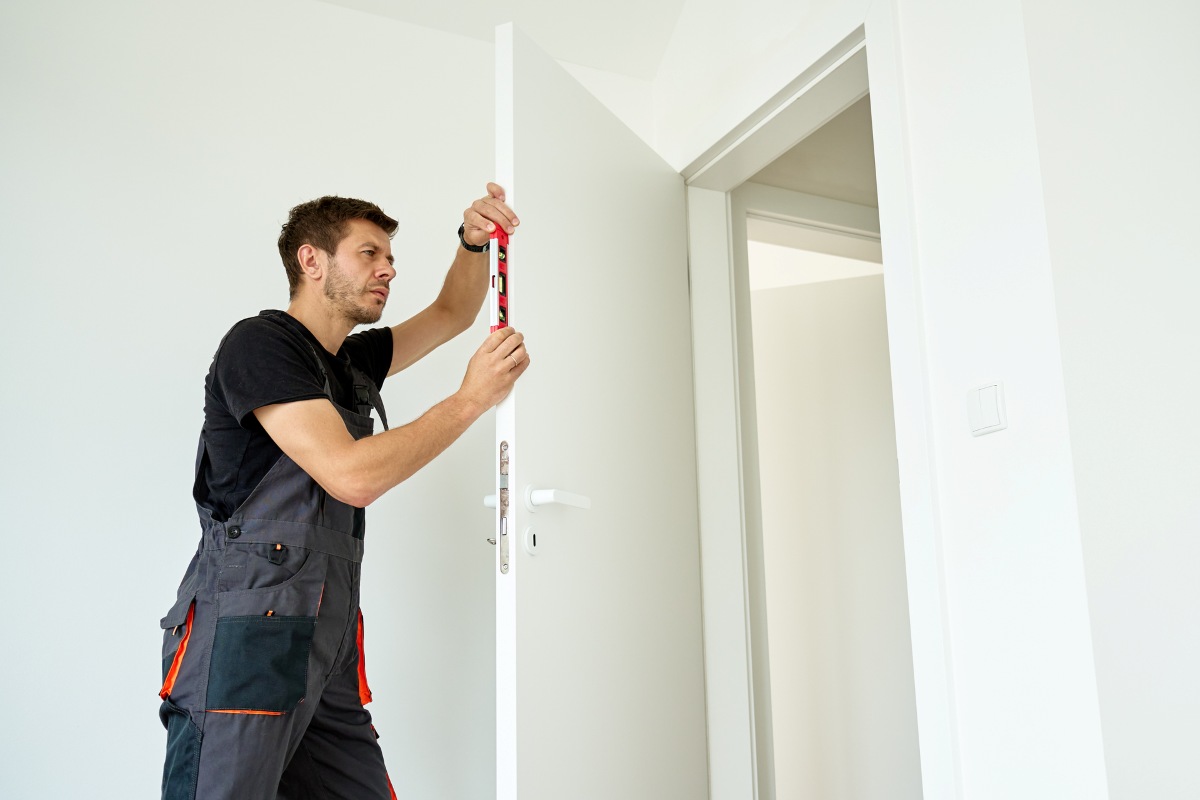 Installing door handle spindle into modern wooden interior structure
