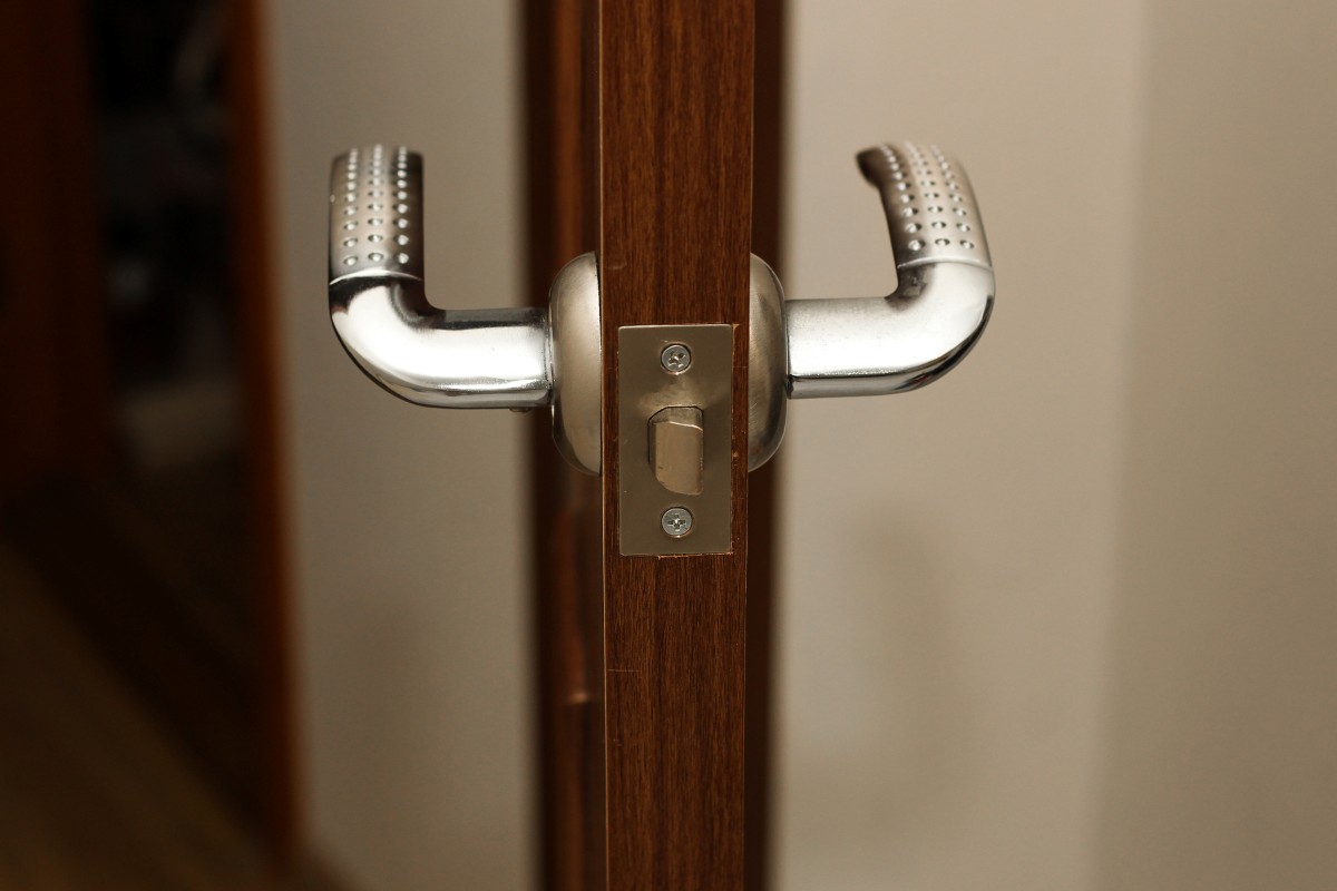 A door lock with a handle on the door in the apartment